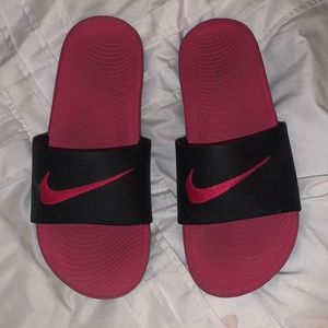 Pink and black Nike slides